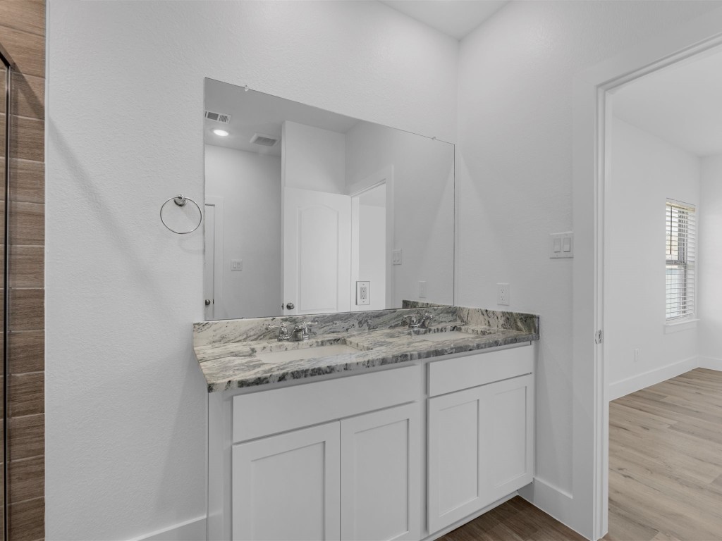 24751 Russet Bluff Trail Houston, TX 77336 - Photo 18 of 26 a bathroom with a granite countertop sink and a mirror
