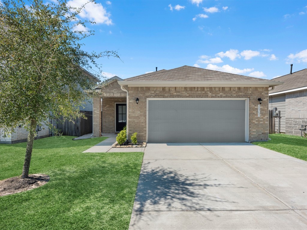 24751 Russet Bluff Trail Houston, TX 77336 - Photo 2 of 26 a front view of a house with a yard and garage