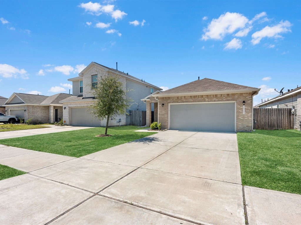 24751 Russet Bluff Trail Houston, TX 77336 - Photo 5 of 26 a front view of a house with a yard and garage