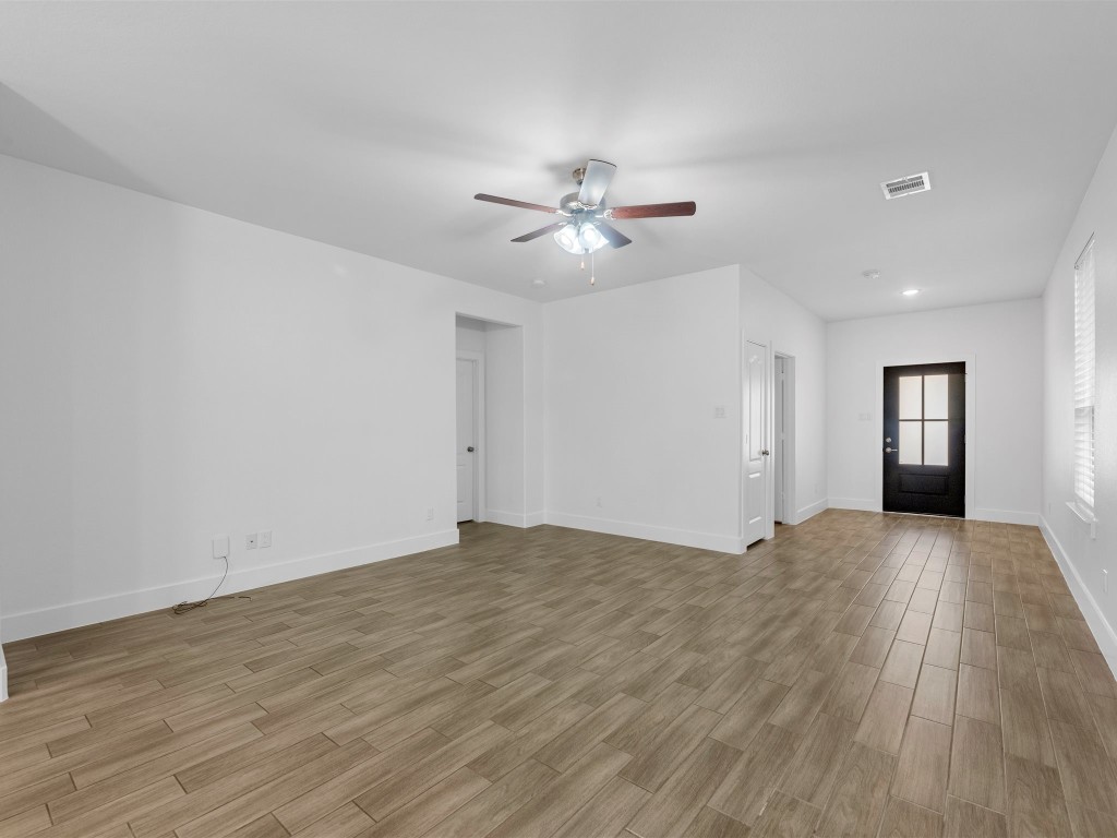 24751 Russet Bluff Trail Houston, TX 77336 - Photo 9 of 26 a view of empty room with wooden floor and fan
