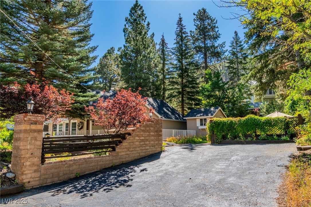 4063 Zugspitz Way Mount Charleston, NV 89124 - Photo 26 of 89 View of patio / terrace with a fenced front yard and asphalt driveway