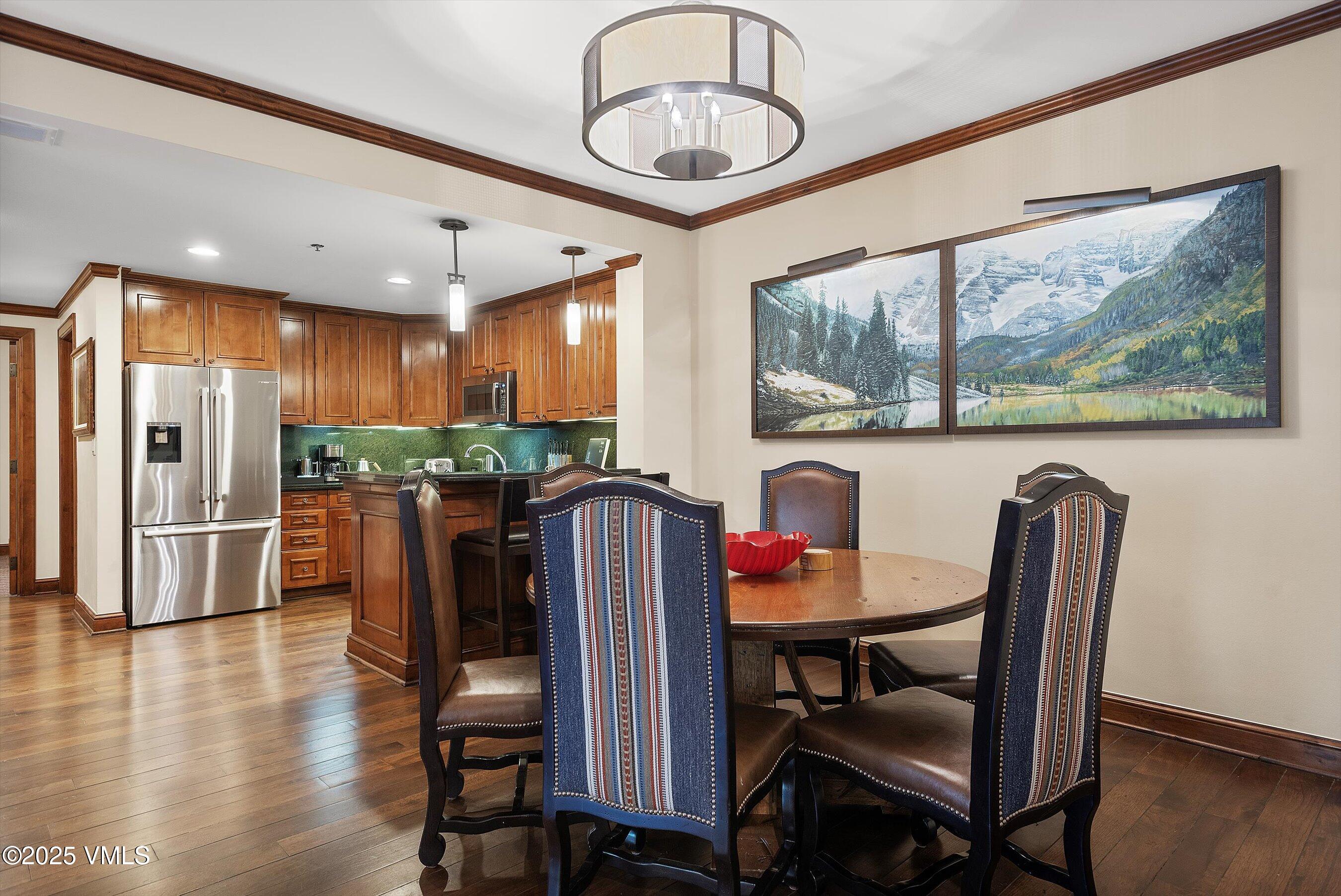 39 Boomerang Road, Unit 841114 Aspen, CO 81611 - Photo 14 of 35 a view of a dining room with furniture window and wooden floor