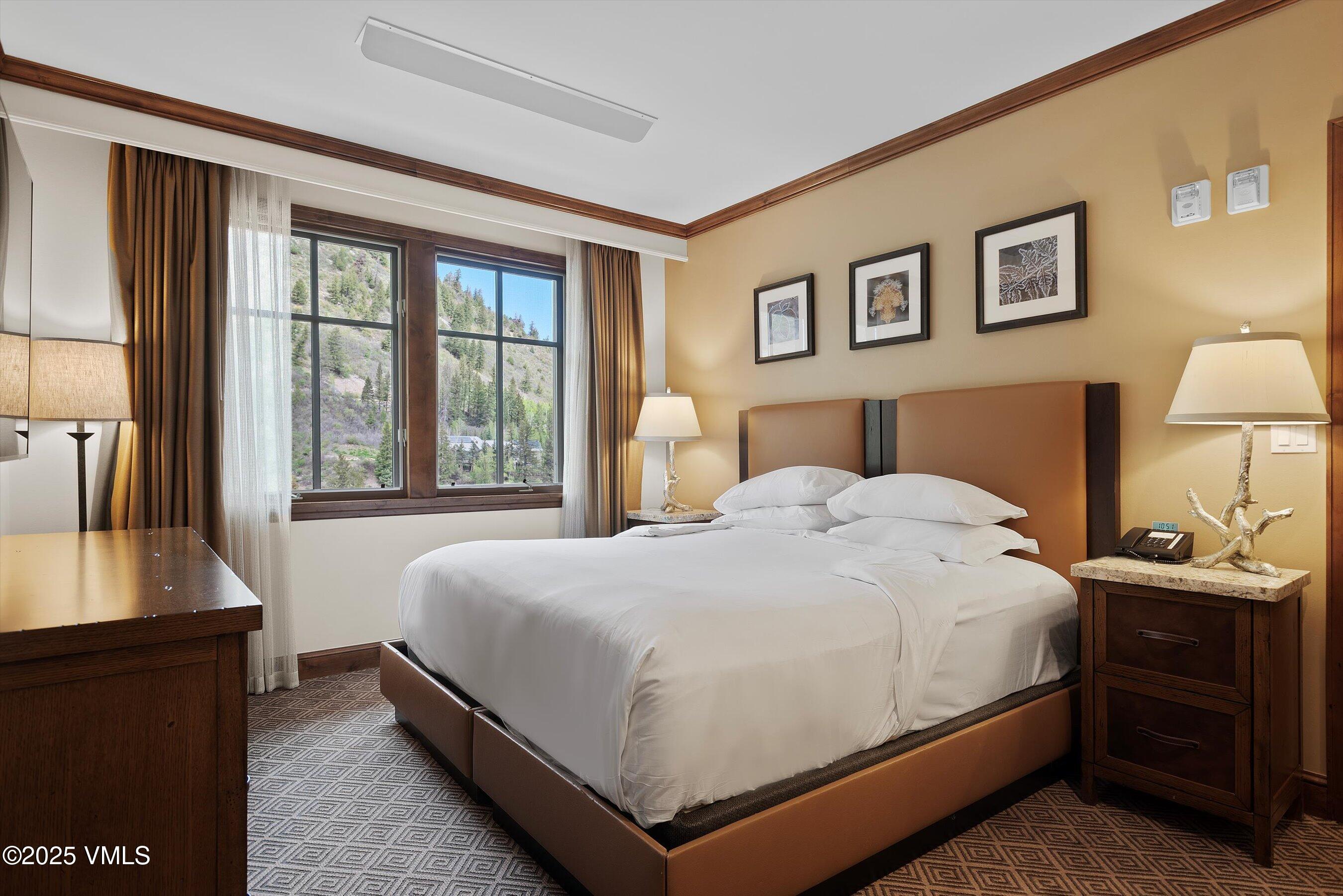 39 Boomerang Road, Unit 841114 Aspen, CO 81611 - Photo 23 of 35 a bedroom with a bed and wooden floor