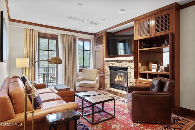 a kitchen with stainless steel appliances granite countertop a stove top oven a sink dishwasher a dining table and chairs with wooden floor