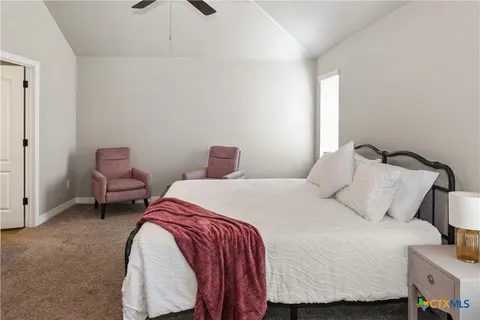 a bedroom with a bed and chair