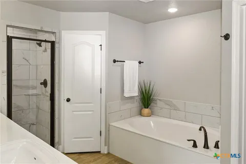 a white bath tub sitting next to a white sink