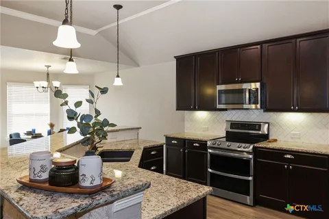 a kitchen with a stove and a microwave