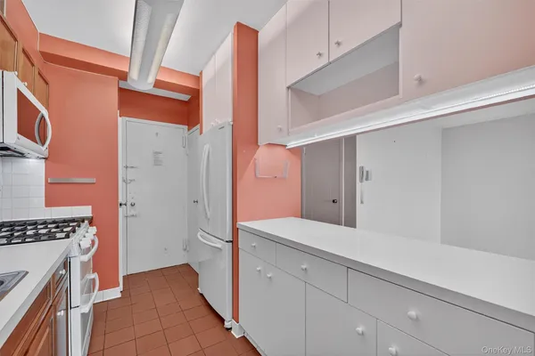 a kitchen with stainless steel appliances granite countertop a stove and a refrigerator