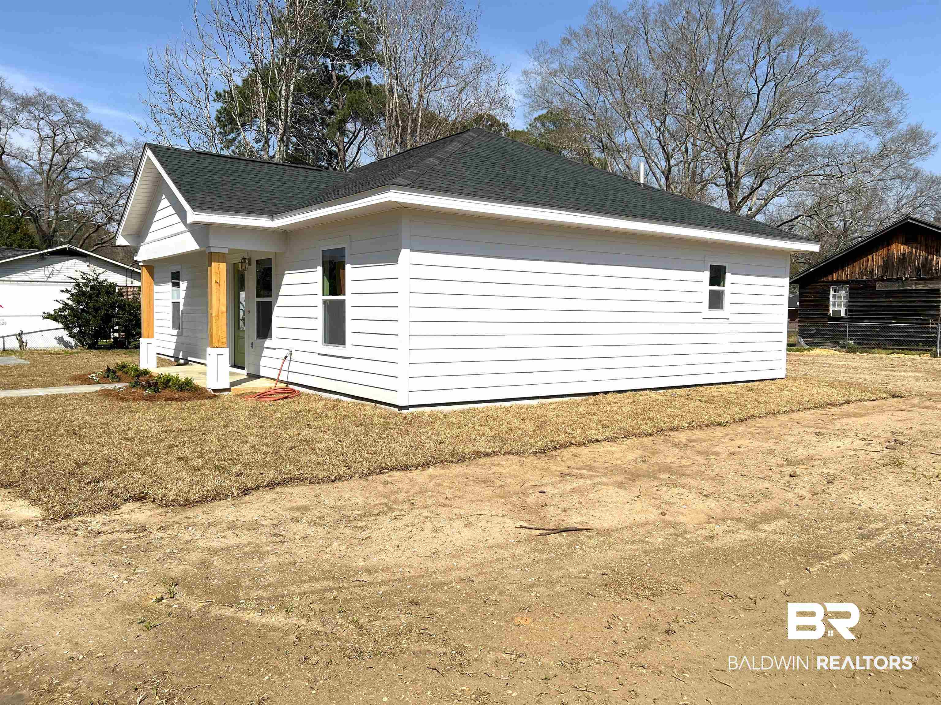 102 Earl Street Brewton, AL 36426 - Photo 20 of 27 View of home's exterior featuring roof with shingles