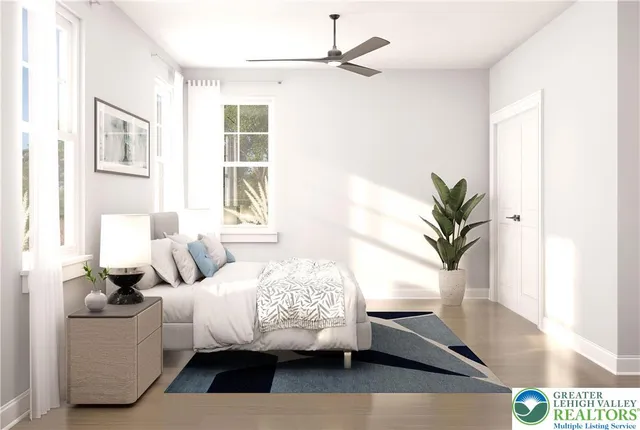 a bedroom with a bed and a potted plant