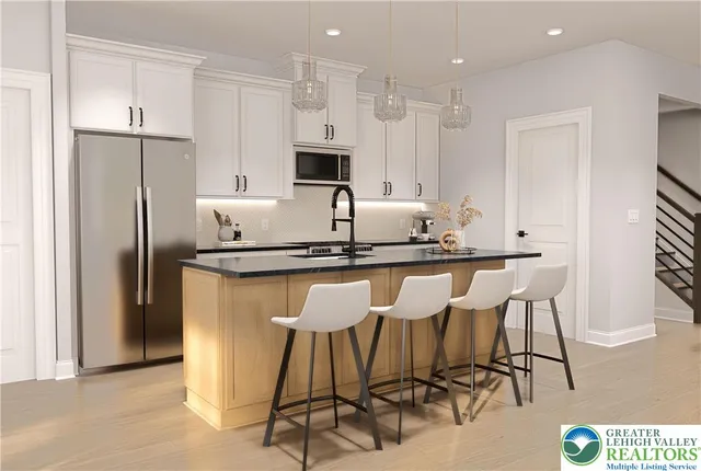 a kitchen with stainless steel appliances kitchen island granite countertop a refrigerator and a stove top oven