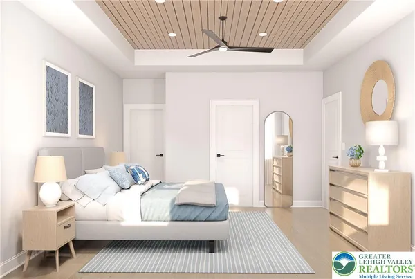 a bedroom with a large bed and a chandelier