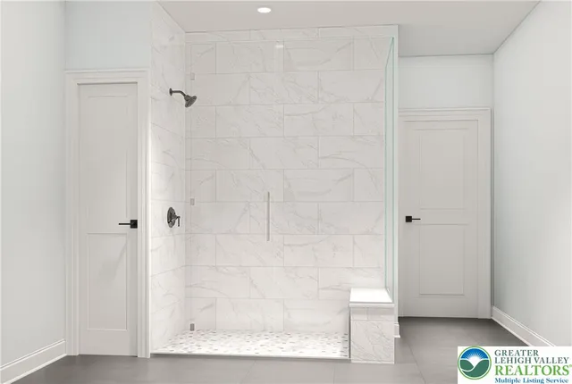 a bathroom with a glass shower door