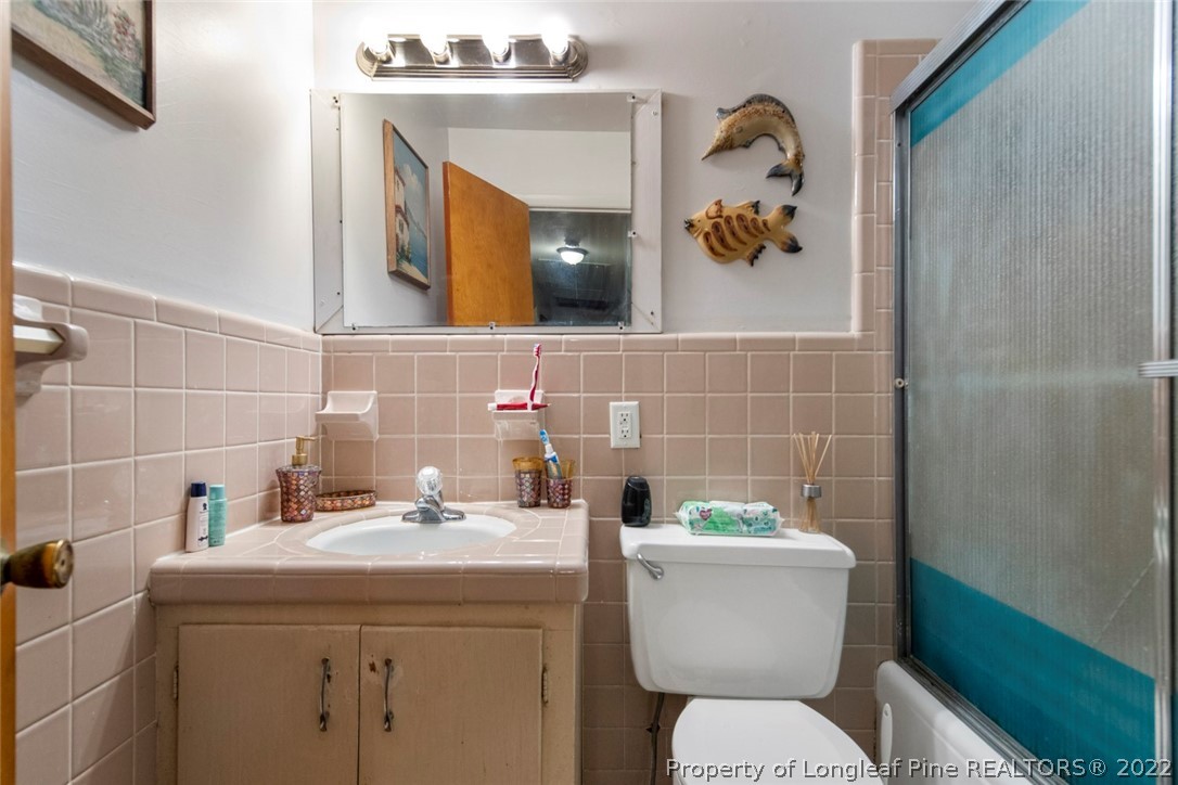 418 Pine Lake Park Road Pembroke, NC 28372 - Photo 11 of 19 a bathroom with a toilet a sink and mirror