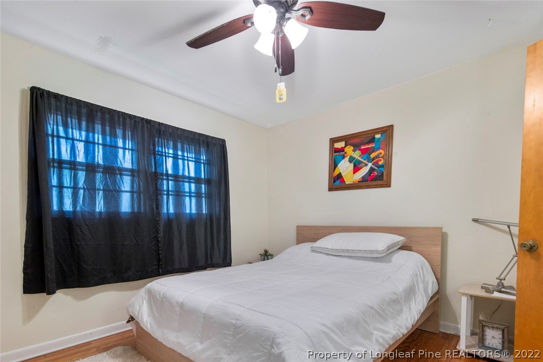 418 Pine Lake Park Road Pembroke, NC 28372 - Photo 14 of 19 a bedroom with a bed and a chandelier