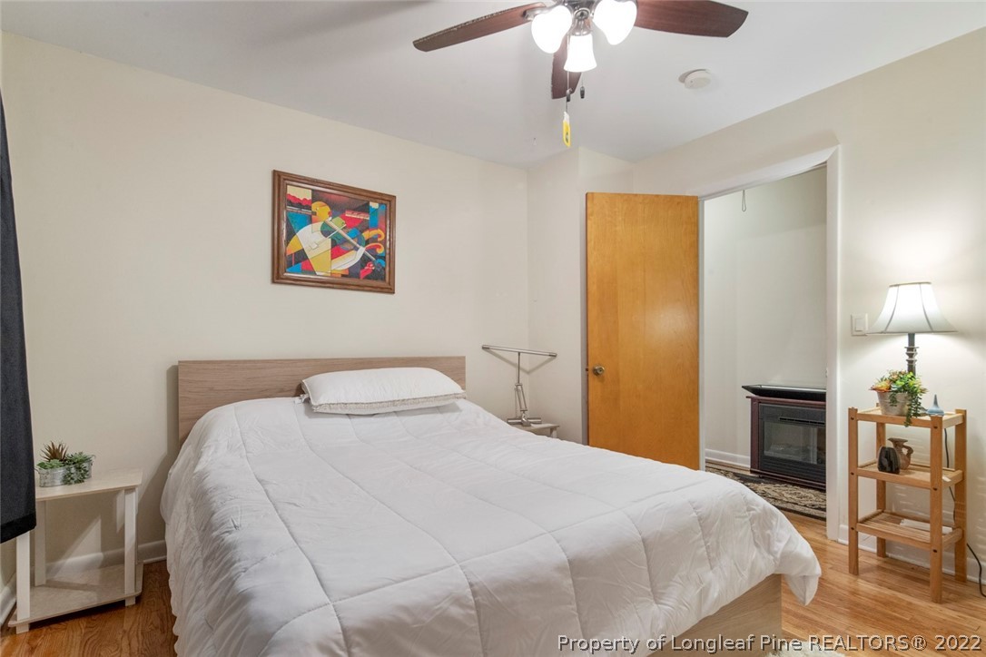 418 Pine Lake Park Road Pembroke, NC 28372 - Photo 15 of 19 a bedroom with a bed and a chandelier