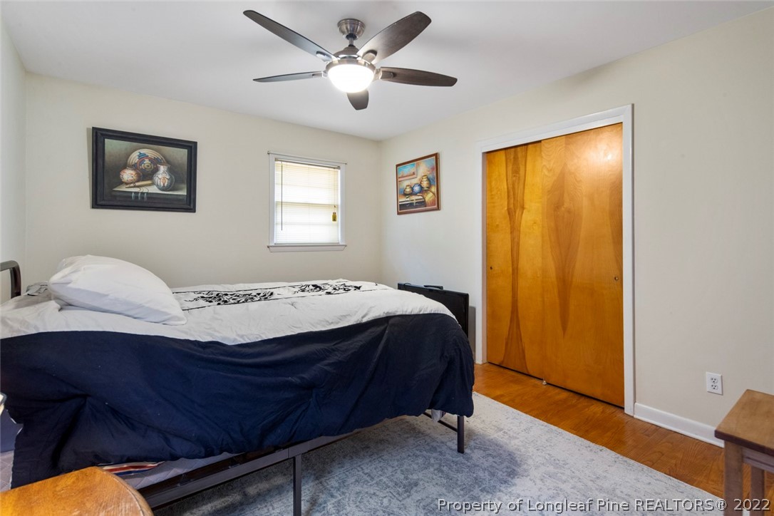 418 Pine Lake Park Road Pembroke, NC 28372 - Photo 17 of 19 a bedroom with a bed and a chandelier