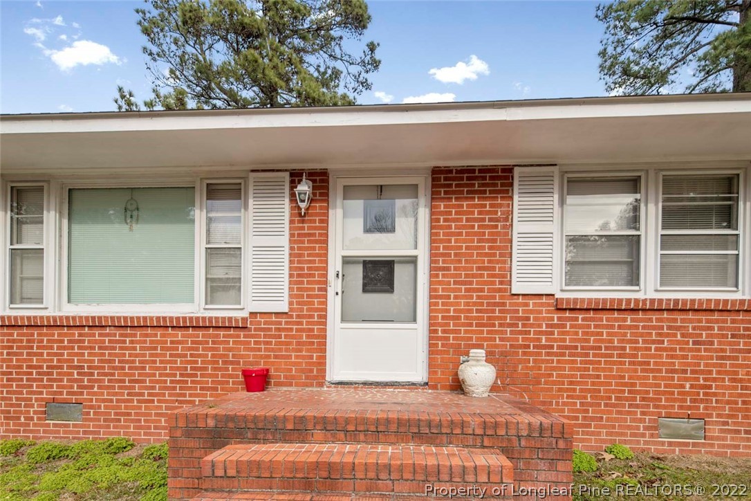 418 Pine Lake Park Road Pembroke, NC 28372 - Photo 3 of 19 a view of a brick house with a window