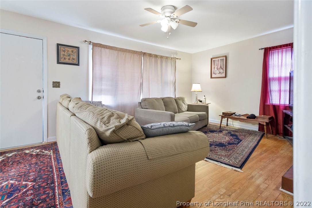 418 Pine Lake Park Road Pembroke, NC 28372 - Photo 4 of 19 a living room with furniture and a chandelier