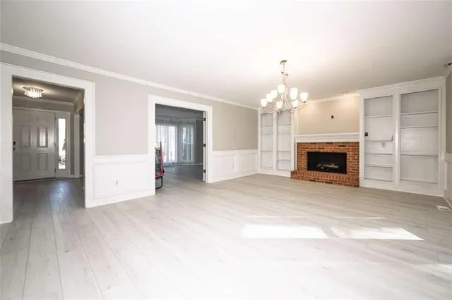 a view of an empty room with a fireplace