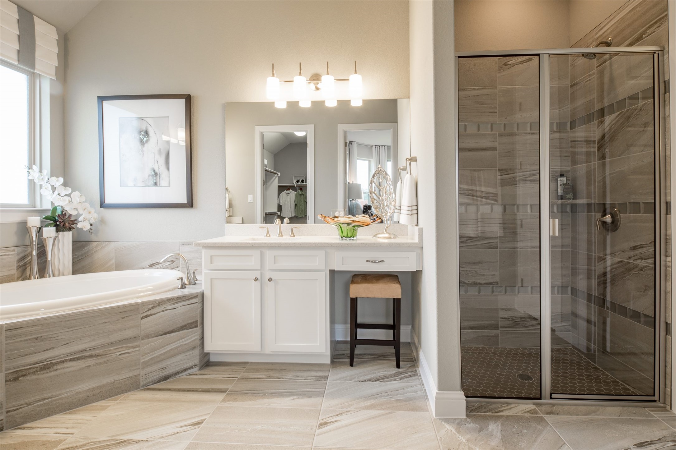 1229 Terrace View Drive Georgetown, TX 78628 - Photo 14 of 17 Luxurious tile flooring and tub surround enhance this elegant bathroom, featuring a spacious walk-in shower and vanity.