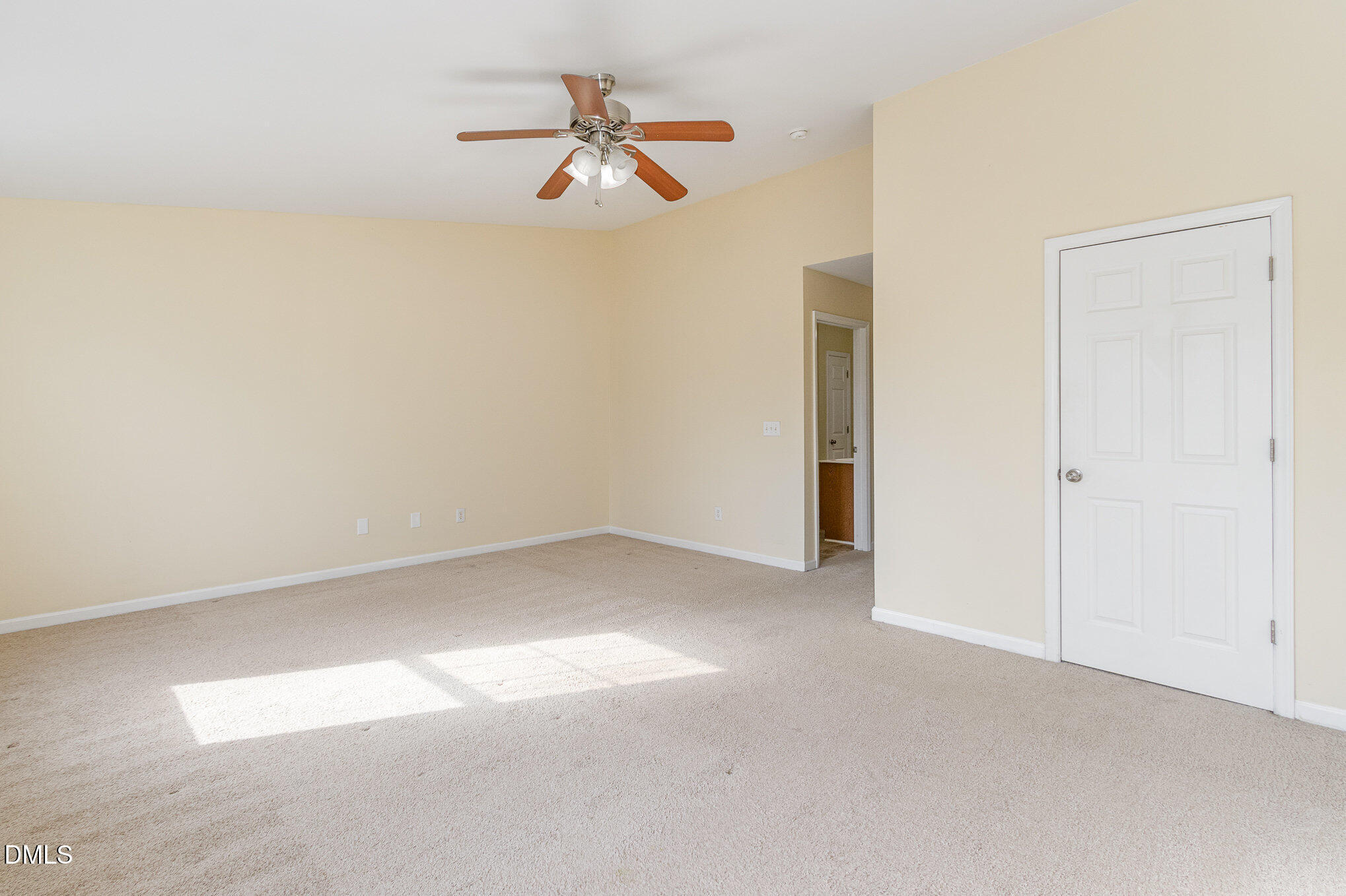 1311 Canyon Rock Court, Unit U105 Raleigh, NC 27610 - Photo 9 of 16 an empty room with a ceiling fan and a window