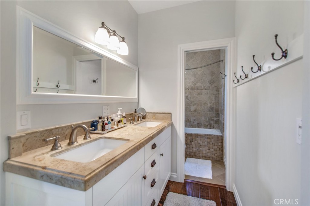 225 16th Place Costa Mesa, CA 92627 - Photo 18 of 43 a bathroom with a sink double vanity granite and a mirror