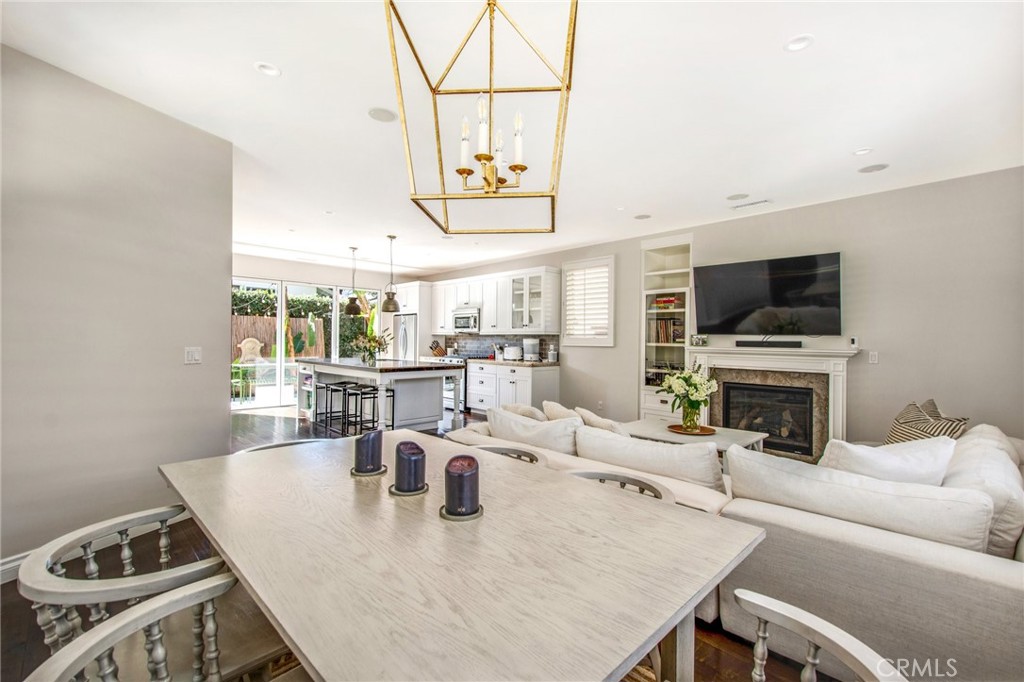 225 16th Place Costa Mesa, CA 92627 - Photo 23 of 43 a living room with furniture a flat screen tv and a floor to ceiling window