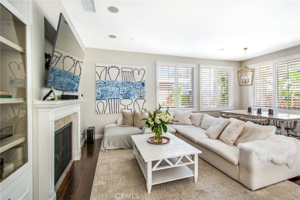 225 16th Place Costa Mesa, CA 92627 - Photo 26 of 43 a living room with furniture a large window and a fireplace