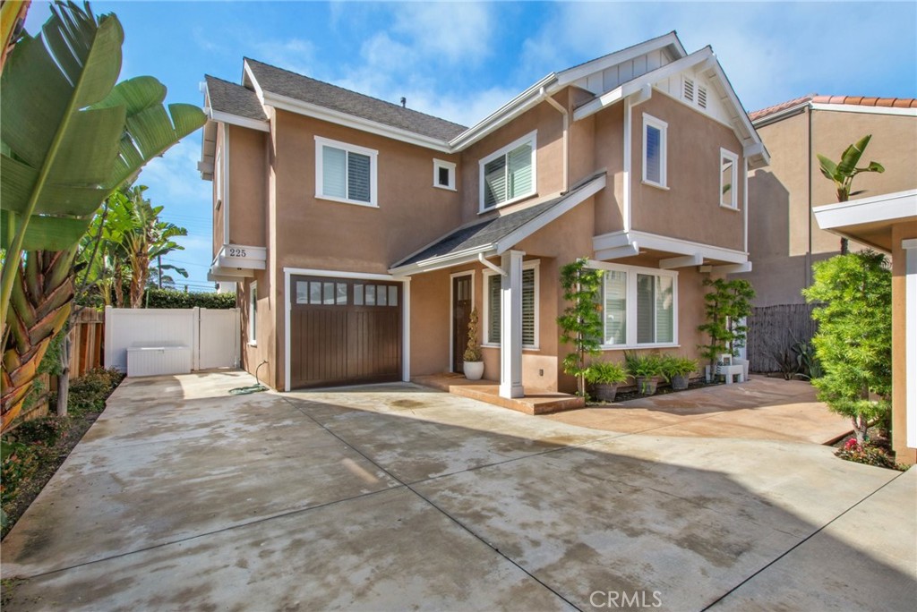 225 16th Place Costa Mesa, CA 92627 - Photo 31 of 43 a front view of a house with a yard and potted plants