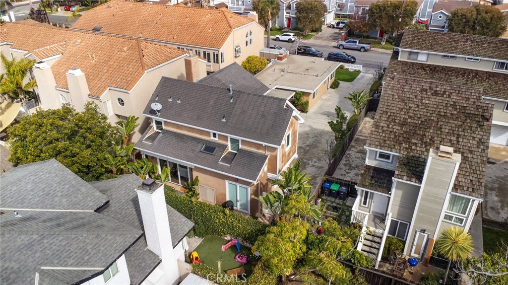 225 16th Place Costa Mesa, CA 92627 - Photo 38 of 43 a aerial view of a house with pool and lawn chairs under an umbrella