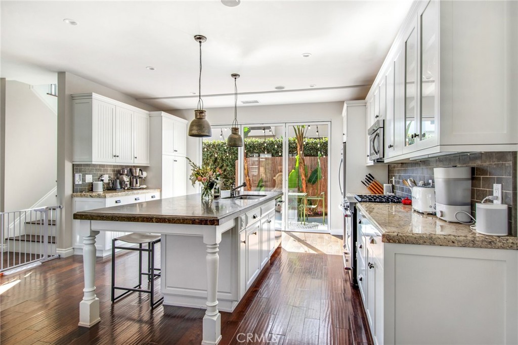 225 16th Place Costa Mesa, CA 92627 - Photo 7 of 43 a kitchen with granite countertop counter space a sink appliances and cabinets