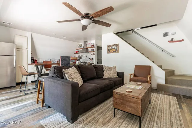 a living room with furniture and a view of kitchen