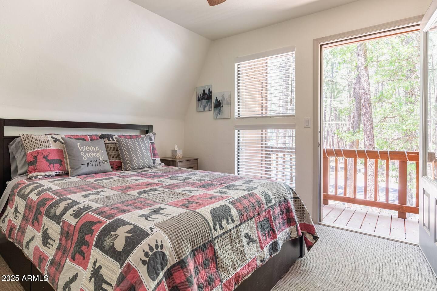 435 Southlake Road Lakeside, AZ 85929 - Photo 21 of 30 a bedroom with a bed and a large window