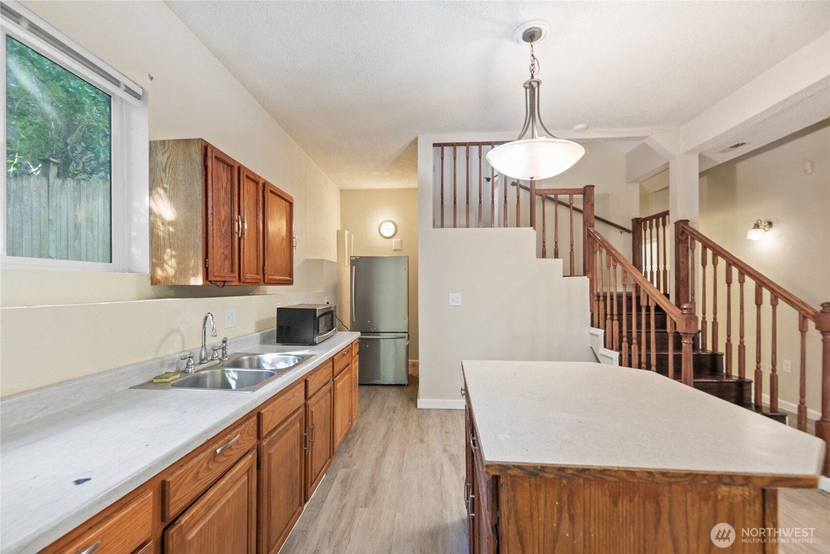 10606 68th Place South Seattle, WA 98178 - Photo 21 of 31 a kitchen with sink a refrigerator and wooden floor