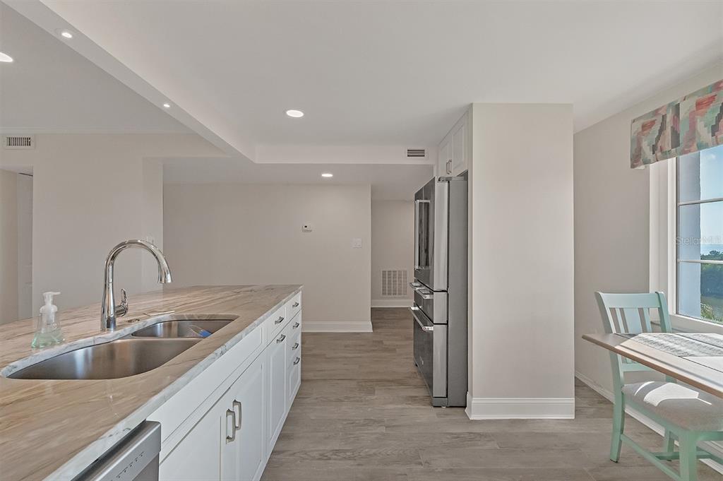 9397 Midnight Pass Road, Unit 501 Sarasota, FL 34242 - Photo 13 of 45 a kitchen with a sink and refrigerator