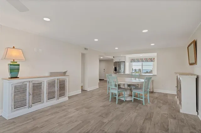a dining room with furniture and wooden floor