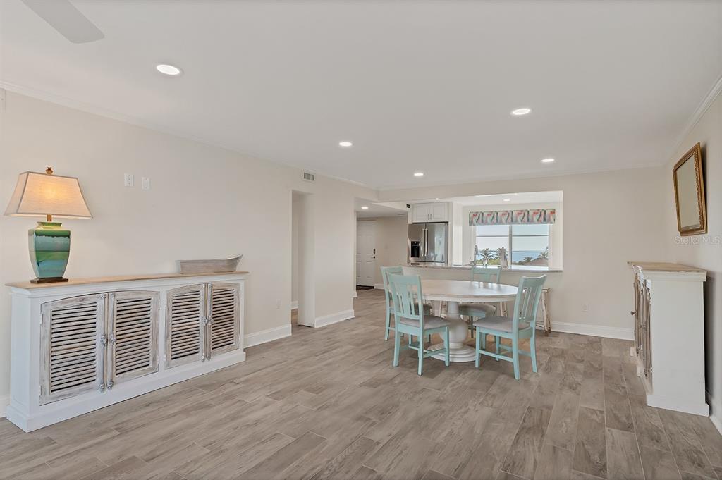 9397 Midnight Pass Road, Unit 501 Sarasota, FL 34242 - Photo 17 of 45 a dining room with furniture and wooden floor