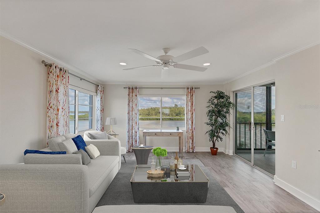 9397 Midnight Pass Road, Unit 501 Sarasota, FL 34242 - Photo 2 of 45 a living room with furniture and potted plants