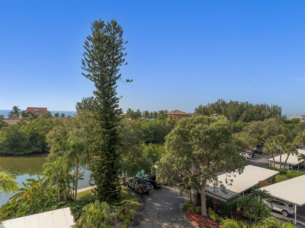 9397 Midnight Pass Road, Unit 501 Sarasota, FL 34242 - Photo 30 of 45 a view of a building with a trees