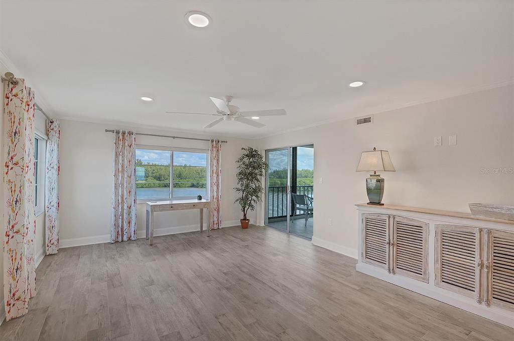 9397 Midnight Pass Road, Unit 501 Sarasota, FL 34242 - Photo 3 of 45 an empty room with wooden floor and windows