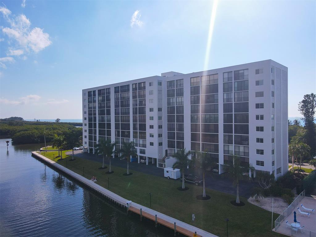 9397 Midnight Pass Road, Unit 501 Sarasota, FL 34242 - Photo 32 of 45 a view of swimming pool with outdoor seating and city view
