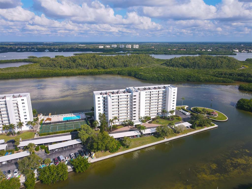 9397 Midnight Pass Road, Unit 501 Sarasota, FL 34242 - Photo 34 of 45 a view of a lake with a mountain in the background