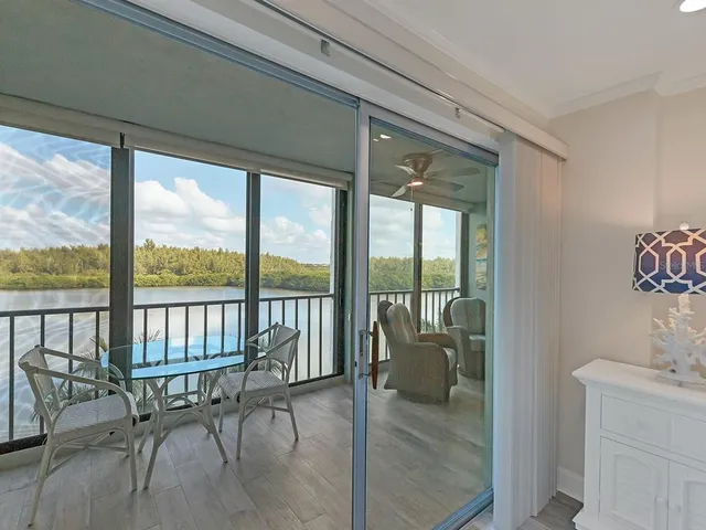 a balcony with table and chairs