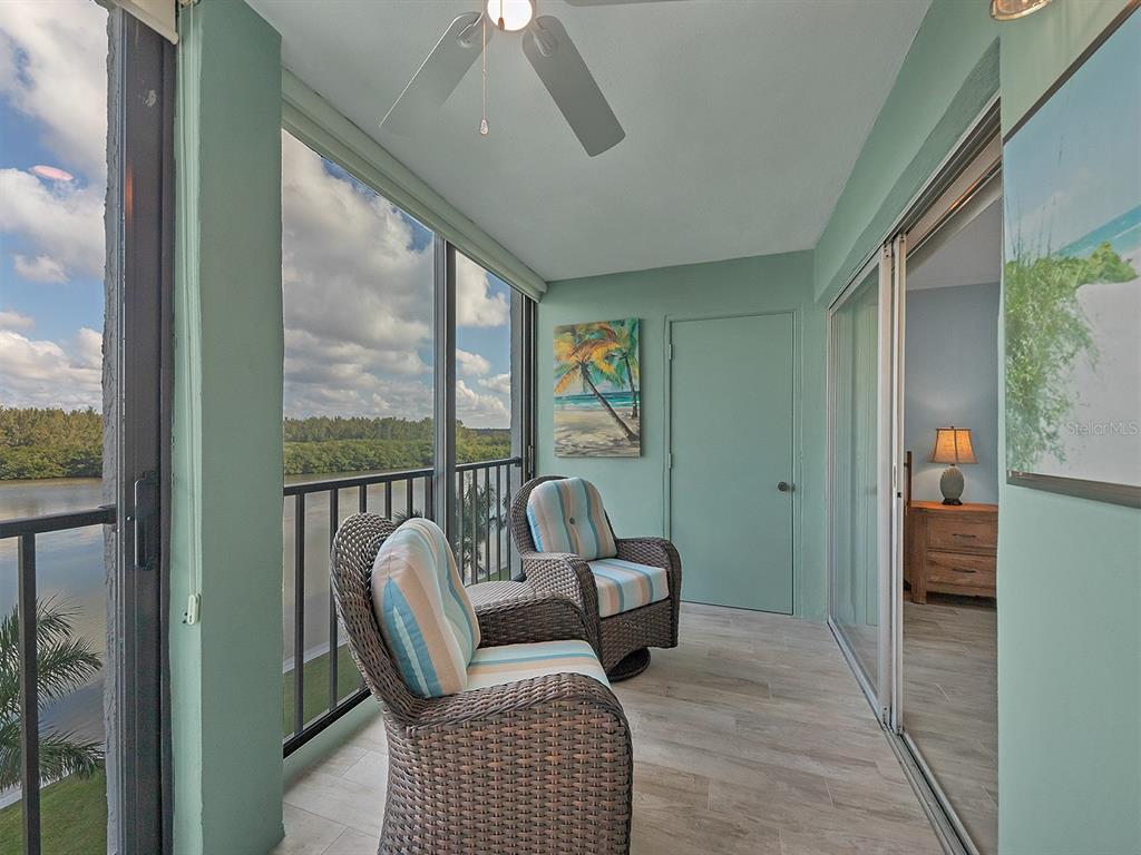 9397 Midnight Pass Road, Unit 501 Sarasota, FL 34242 - Photo 5 of 45 a balcony with furniture and view of bedroom