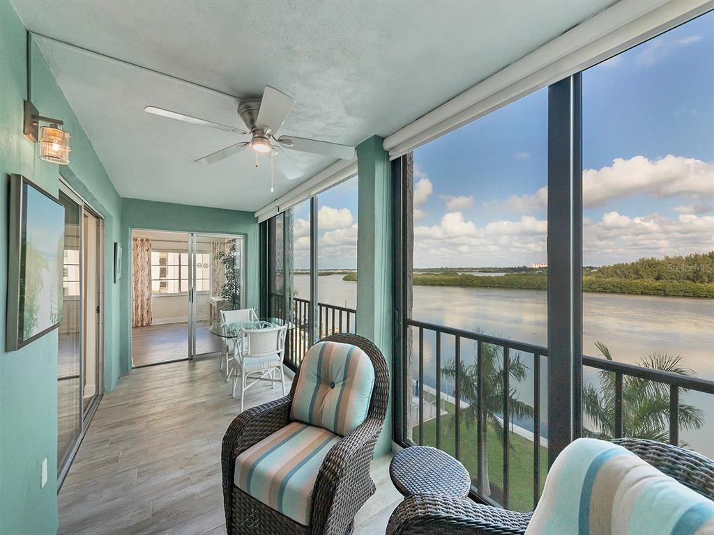 9397 Midnight Pass Road, Unit 501 Sarasota, FL 34242 - Photo 6 of 45 a living room with furniture and a floor to ceiling window