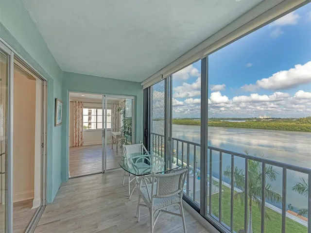 a view of a room with wooden floor and furniture