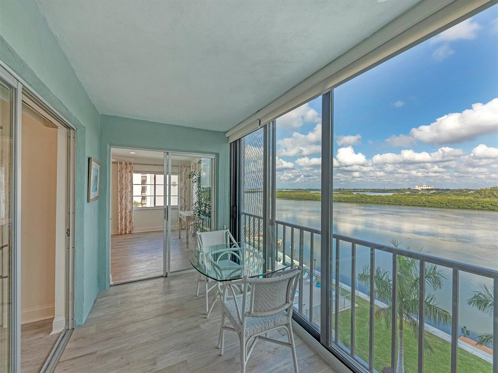 9397 Midnight Pass Road, Unit 501 Sarasota, FL 34242 - Photo 7 of 45 a view of a room with wooden floor and furniture