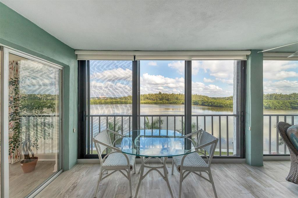 9397 Midnight Pass Road, Unit 501 Sarasota, FL 34242 - Photo 9 of 45 a view of a room with wooden floor and chair