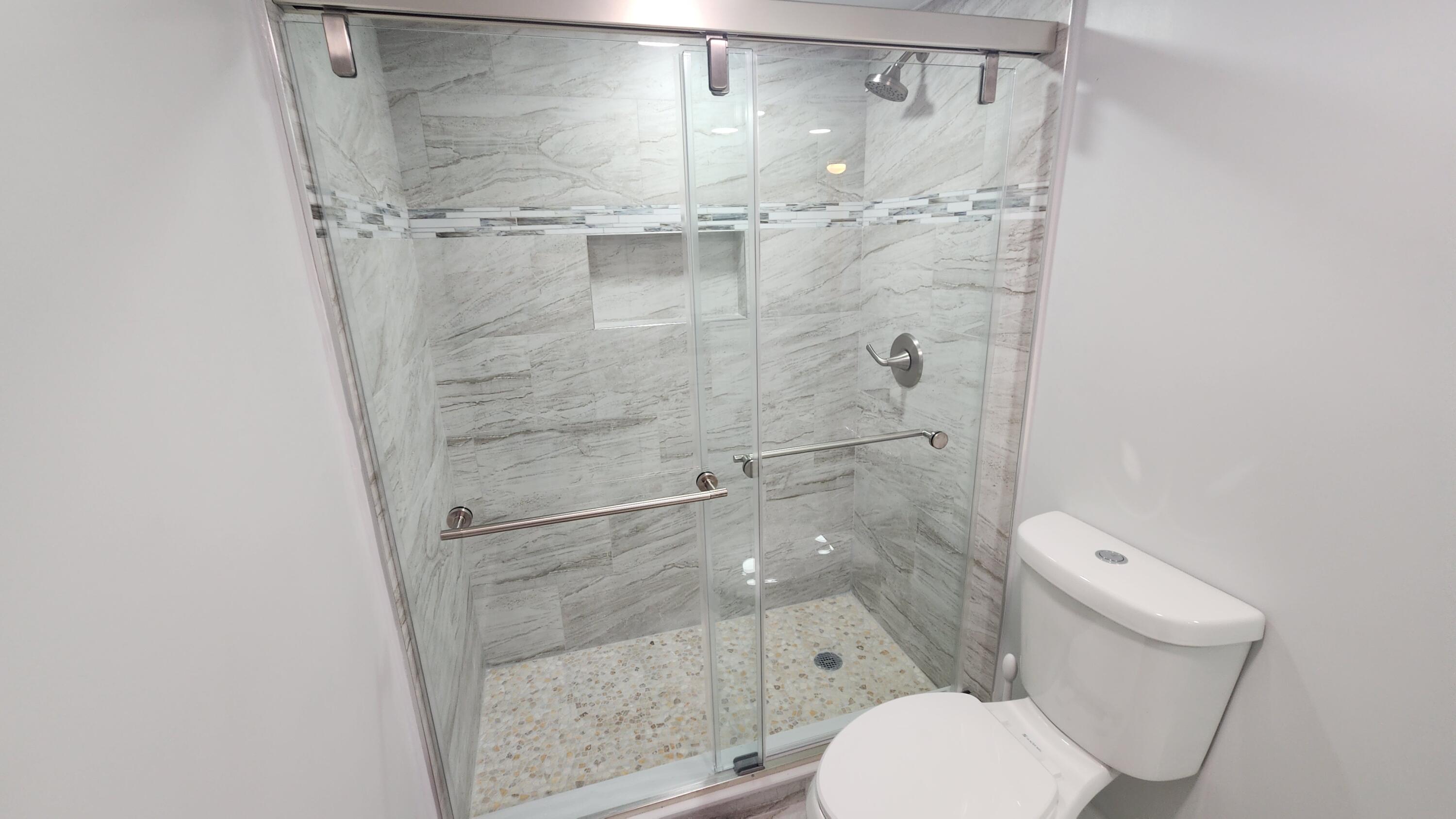 171 Deer Creek Boulevard, Unit 701 Deerfield Beach, FL 33442 - Photo 17 of 23 a bathroom with a toilet and a shower